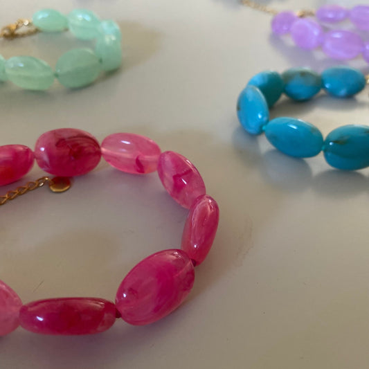 Alle Handgemaakte en verstelbare armband met opvallende acrylkralen afgewerkt met stainless steel kettinkje.