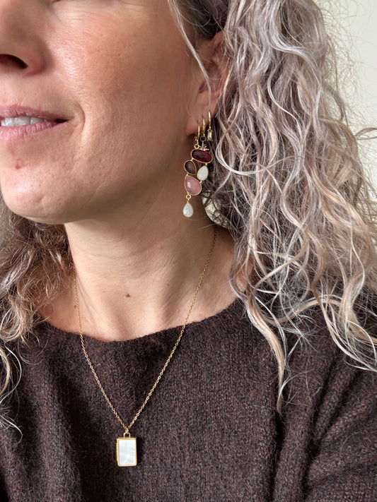 Speelse 14k vergulde oorbellen met een trosje edelstenen in framboosrood, zachtroze, rookkwart en witte maansteen, licht van gewicht en ca. middellange lengte.