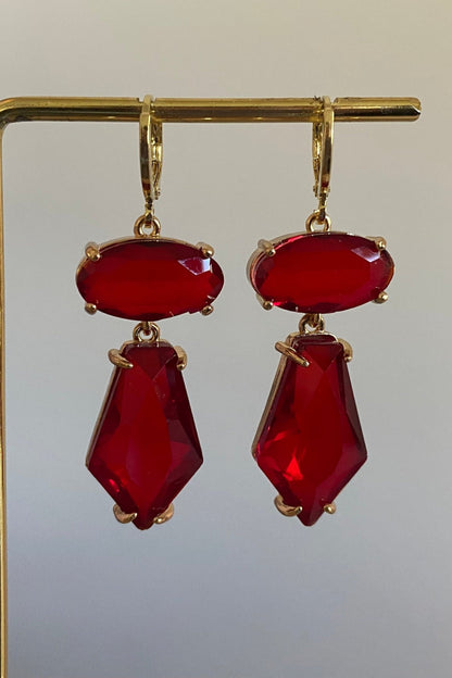 Handgemaakte statement oorbellen met rode glasbedels in ovalen en vijfhoekige bedel aan een 14K verguld oorringetje.