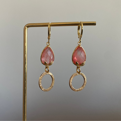 Korte oorbel met roze peervormige steen met bladgoud en kleine gehamerde cirkel, circa 3 cm lang.