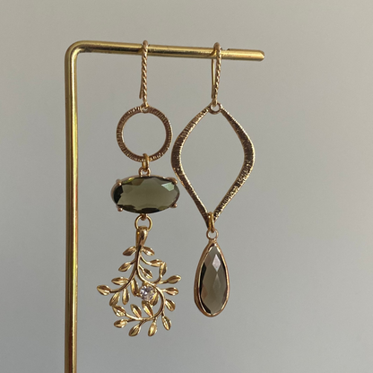 Asymmetrisch oorbelpaar met taupe glasbedel, 14k vergulde takvormige bedel en gehamerde druppel