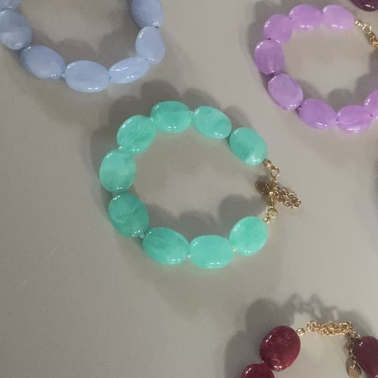 filmpje van Verstelbare armbanden van wijnrode acryl kralen met 14K vergulde sluiting